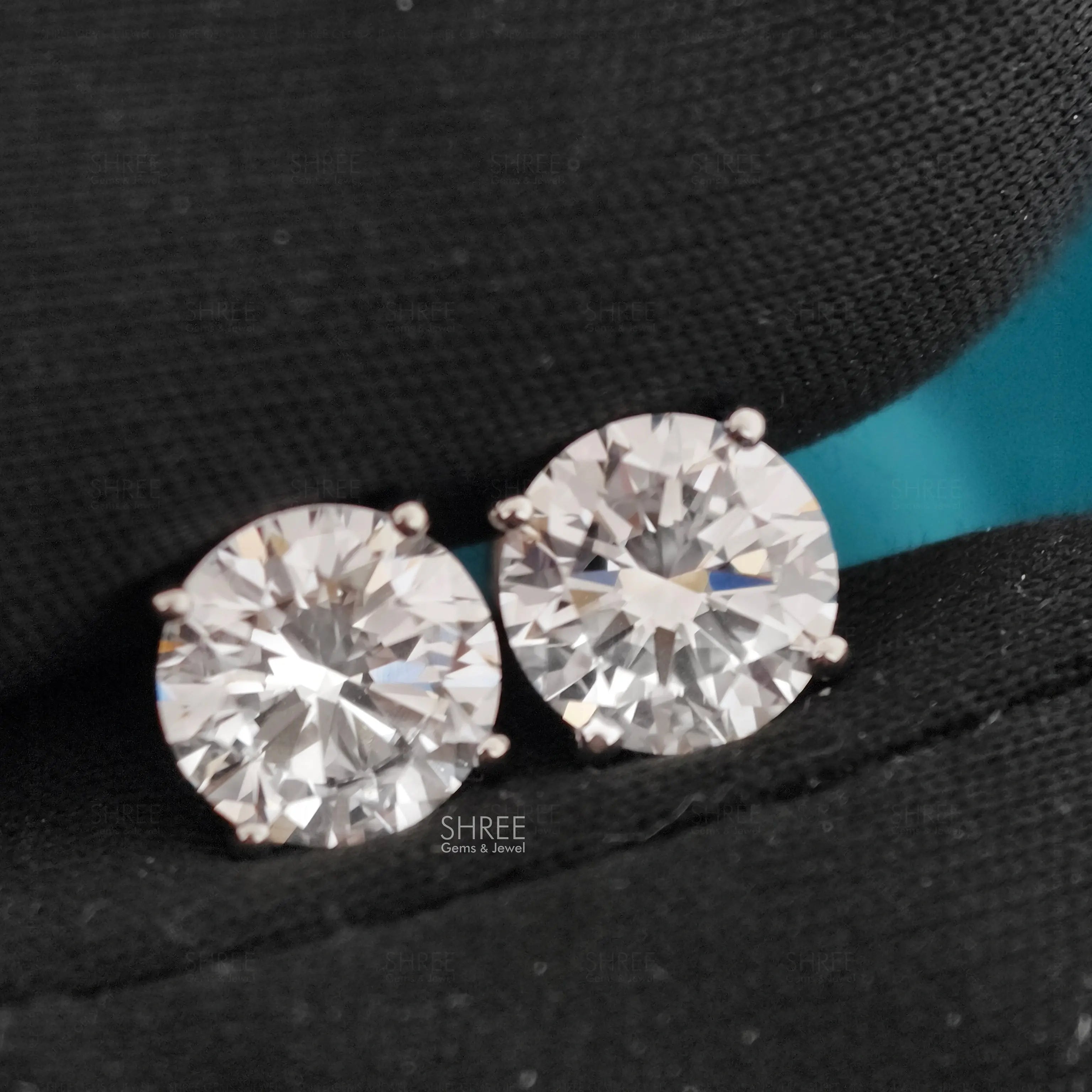Pair of Diamond Stud Earrings on A Black Background with 'shree' Branding.