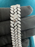 Lab Created Diamond Tennis Bracelet Held by A Gloved Hand