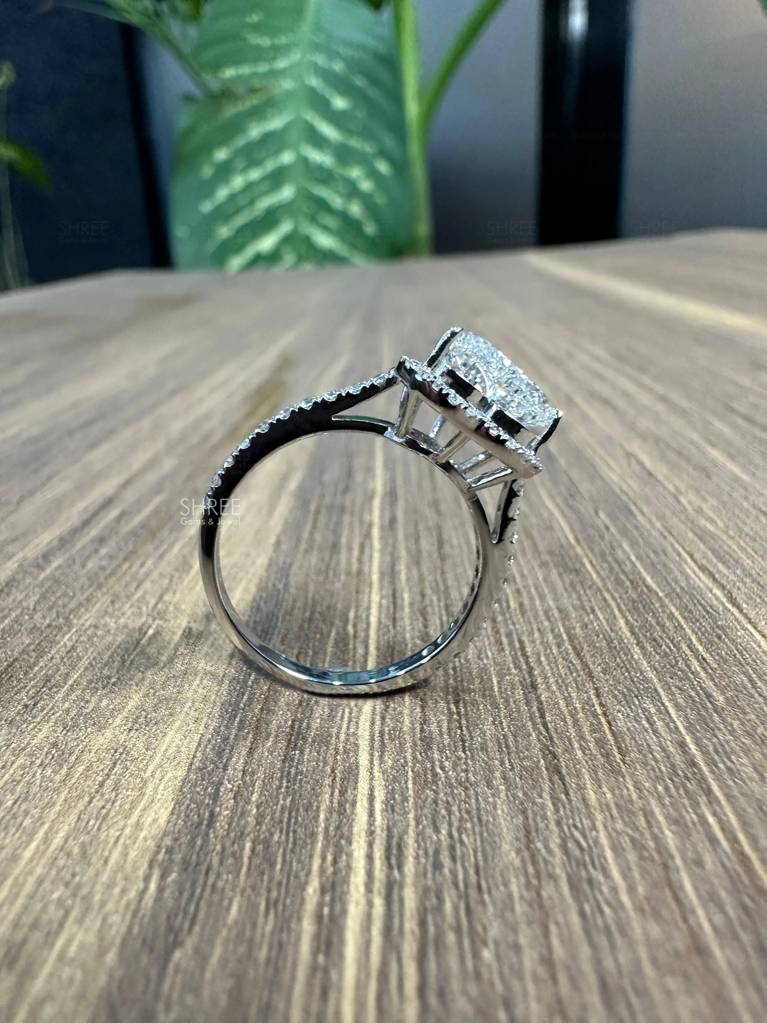 Side view of engagement rings with diamond halo
