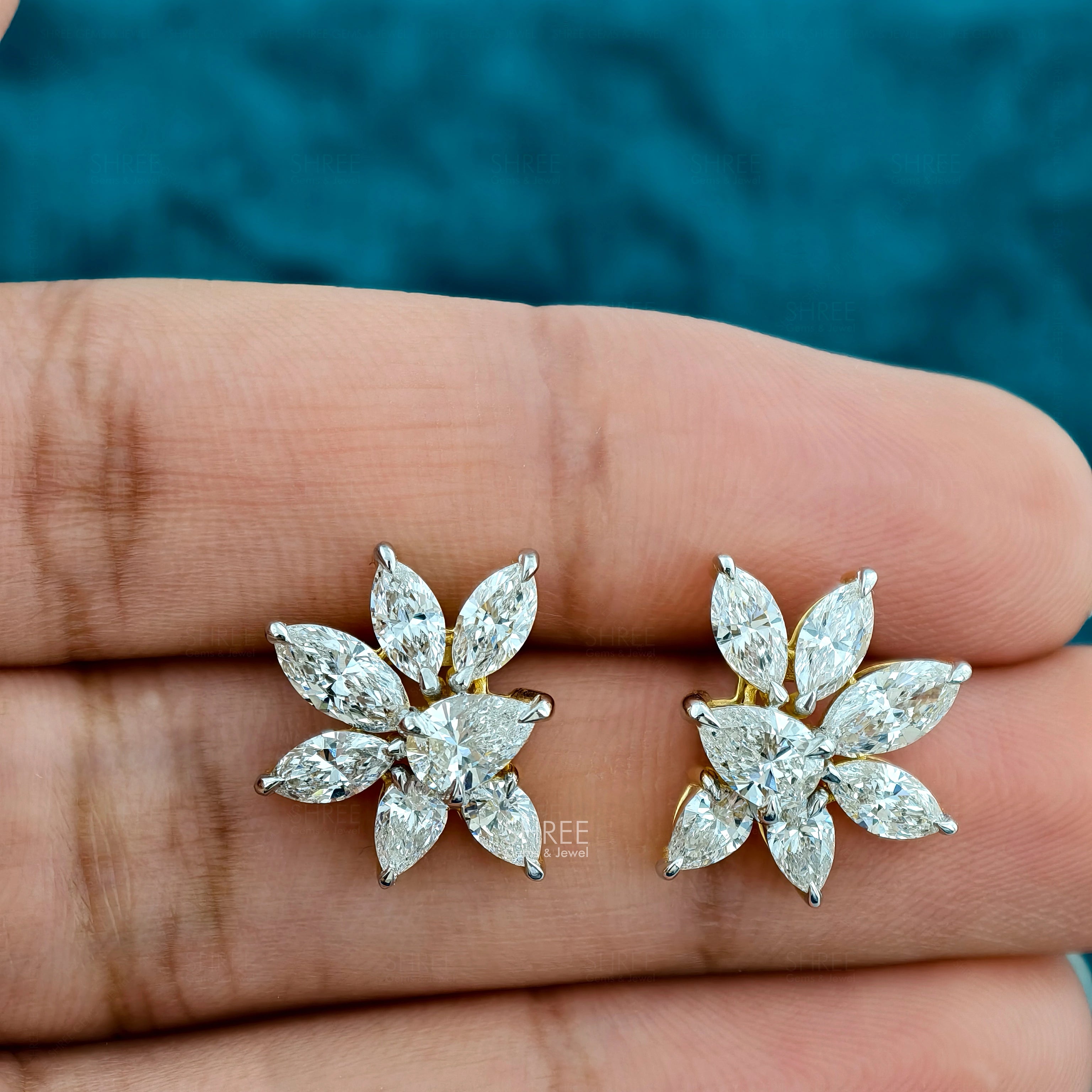 Pear & Marquise Shape Lab Diamond Cluster Stud Earrings Held Between Fingers 