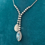 side view of pear shape diamond necklace​
